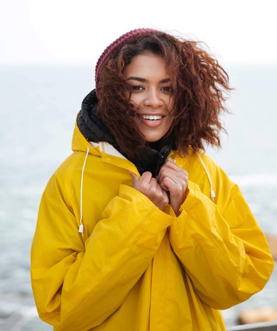 happy-african-curly-young-woman-wearing-yellow-PFCN4PV.jpg